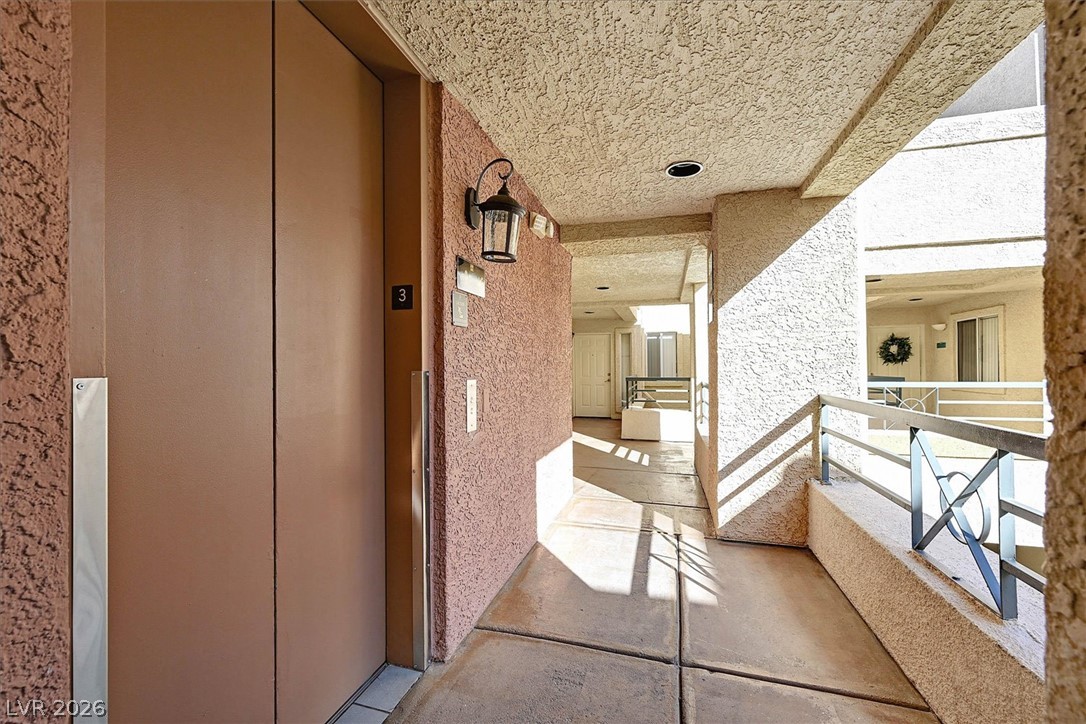 220 East Flamingo Road, Unit 305 Las Vegas, NV 89169 - Photo 24 of 26 Elevator access within this multi-level property, bathed in sunlight along an outdoor walkway.