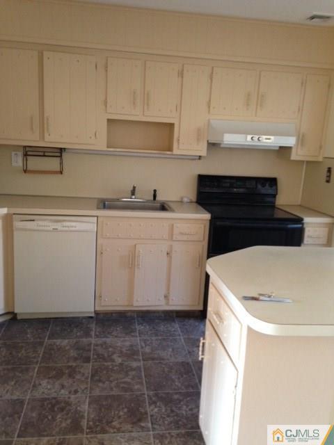 171 Midfield Road Colonia, NJ 07067 - Photo 2 of 12 a kitchen with a sink a stove and cabinets