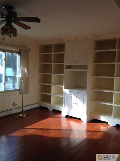 171 Midfield Road Colonia, NJ 07067 - Photo 4 of 12 wooden floor in an empty room with a window
