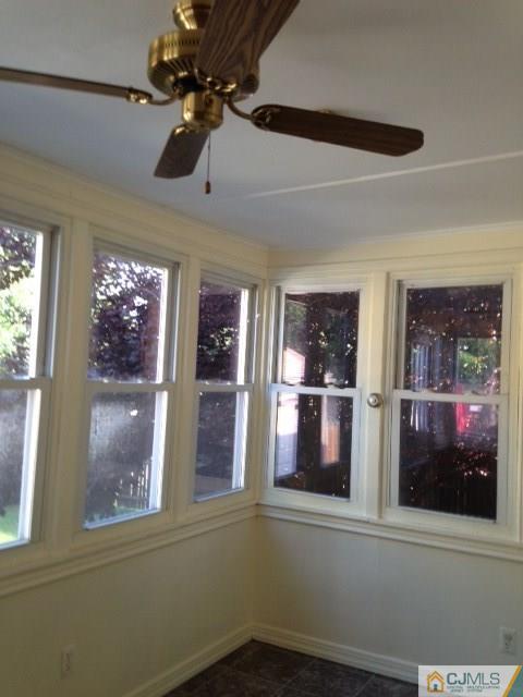 171 Midfield Road Colonia, NJ 07067 - Photo 6 of 12 a view of a brick house with a large window