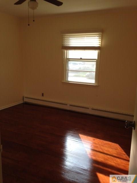 171 Midfield Road Colonia, NJ 07067 - Photo 8 of 12 a view of a room with wooden floor and a window