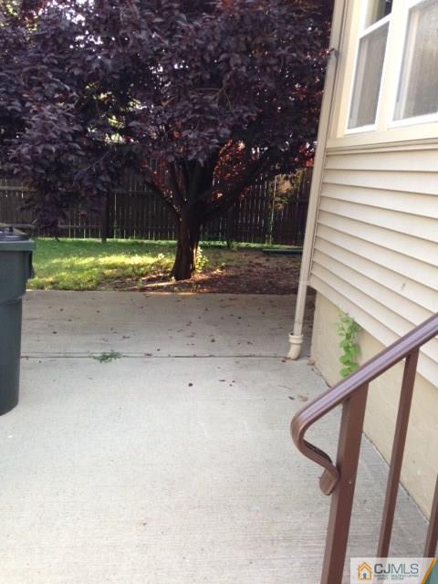 171 Midfield Road Colonia, NJ 07067 - Photo 10 of 12 a view of a house with a small yard and a large tree