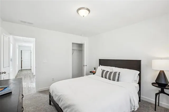 a bedroom with a bed and chair