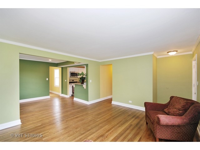 27-w003 Geneva Road Wheaton, IL 60187 - Photo 4 of 16 a view of an empty room with wooden floor and a window