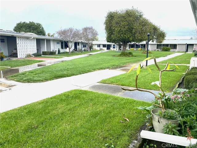 a view of a house with a backyard