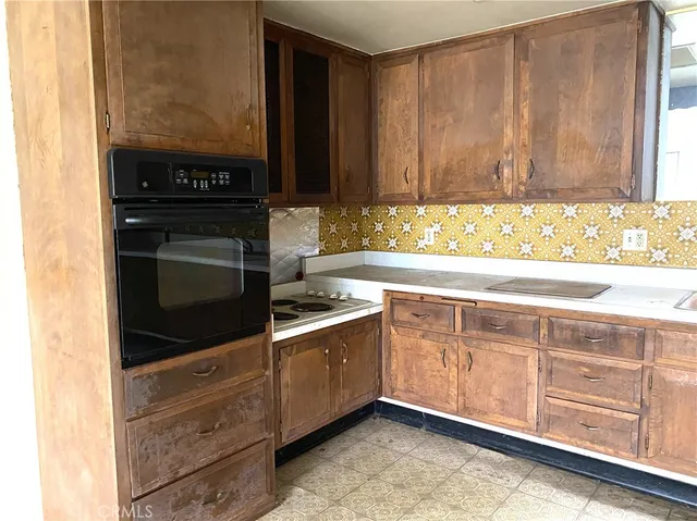 a kitchen with granite countertop cabinets and window