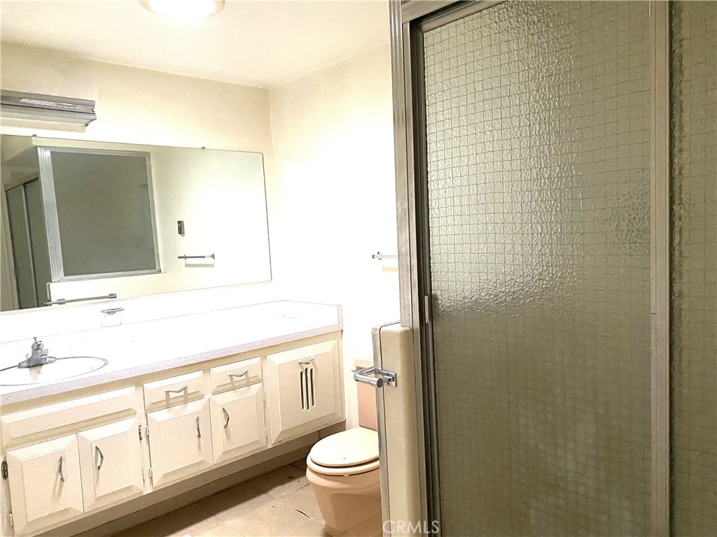 1621 Monterey Road Seal Beach, CA 90740 - Photo 10 of 10 a bathroom with a granite countertop toilet sink and mirror