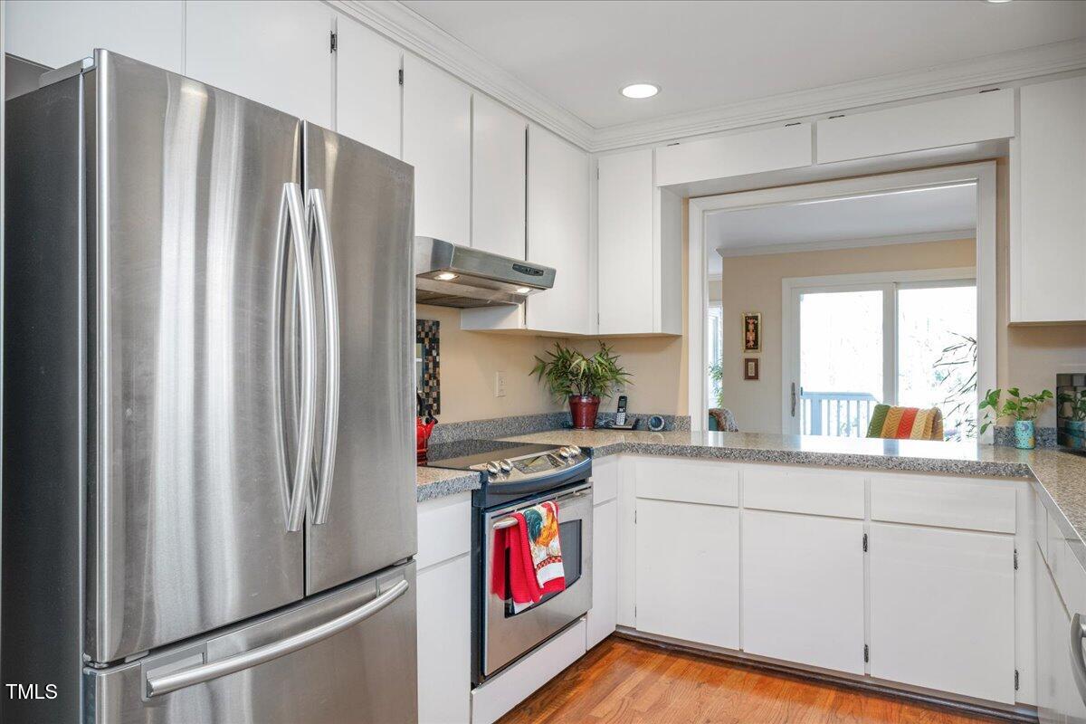 55 Stoneridge Road Durham, NC 27705 - Photo 4 of 35 a kitchen with stainless steel appliances granite countertop a refrigerator a stove and a sink