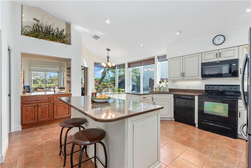 13265 Harbour Ridge Boulevard Palm City, FL 34990 - Photo 1 of 42 a kitchen with microwave a stove and cabinets