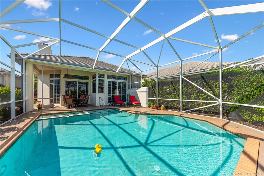 13265 Harbour Ridge Boulevard Palm City, FL 34990 - Photo 26 of 42 a view of a swimming pool with a patio and a yard