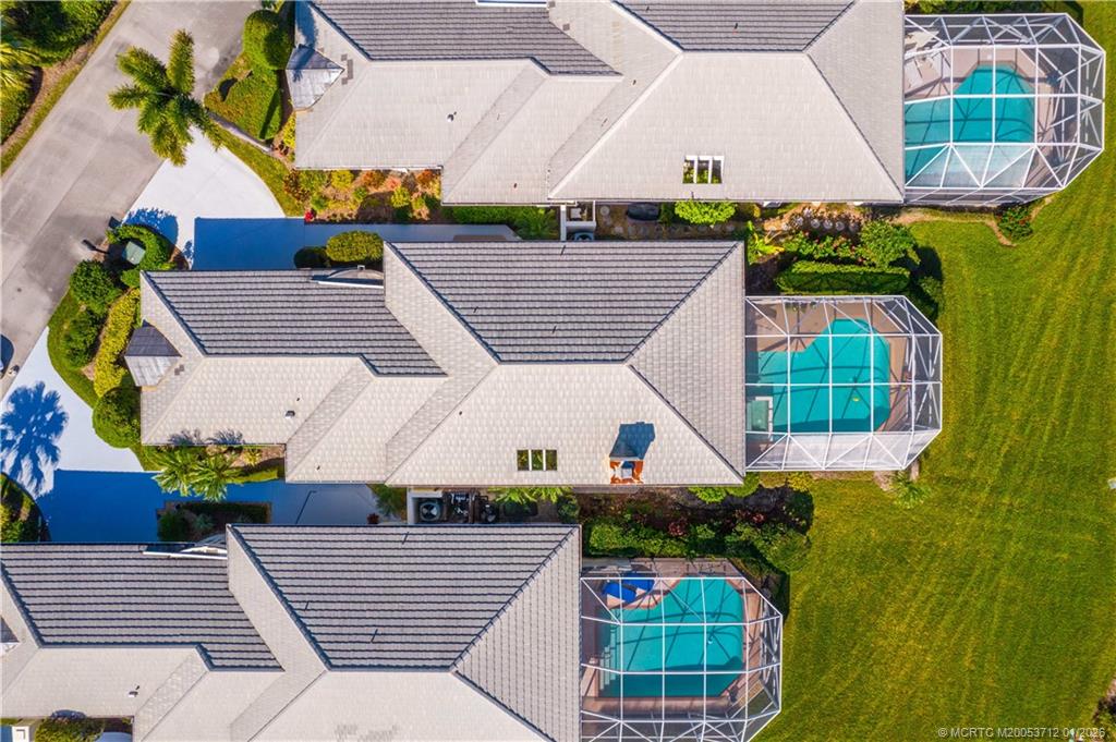 13265 Harbour Ridge Boulevard Palm City, FL 34990 - Photo 29 of 42 an aerial view of a house with a yard and potted plants