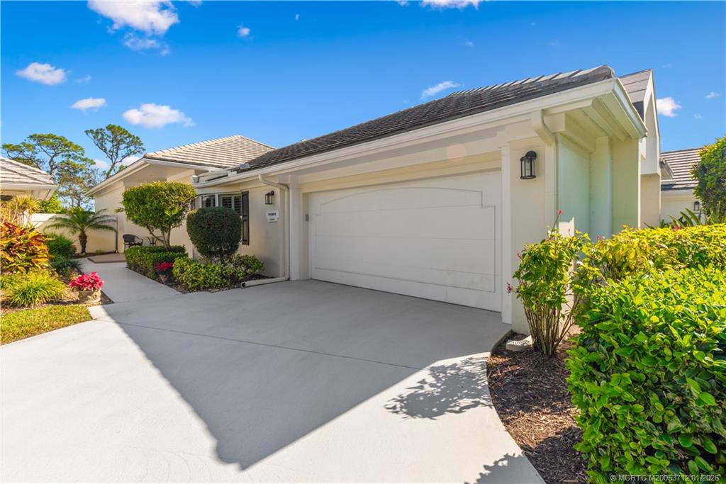 13265 Harbour Ridge Boulevard Palm City, FL 34990 - Photo 32 of 42 a front view of a house with garden