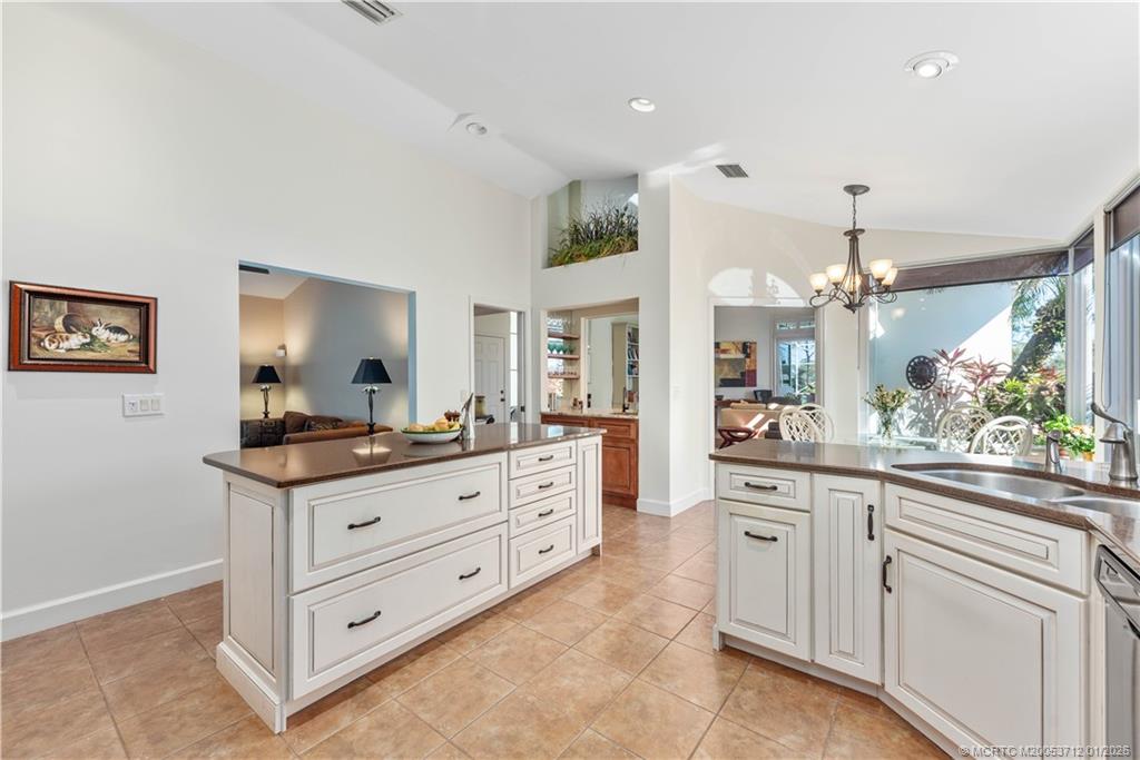 13265 Harbour Ridge Boulevard Palm City, FL 34990 - Photo 5 of 42 a kitchen with granite countertop a sink and cabinets