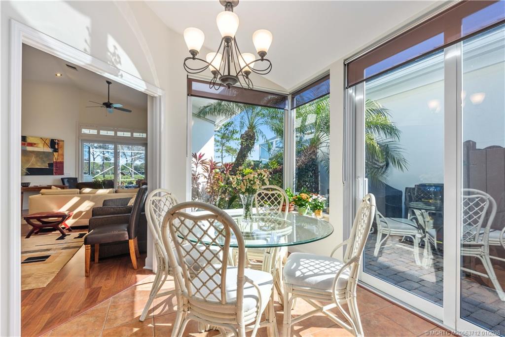 13265 Harbour Ridge Boulevard Palm City, FL 34990 - Photo 6 of 42 a view of a dining room with furniture wooden floor and chandelier