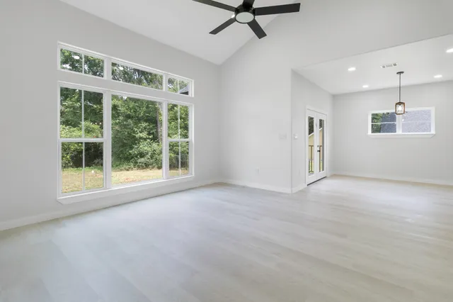 a view of a livingroom with a ceiling fan and window