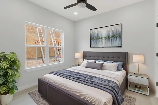 a bedroom with a bed and a painting on the wall