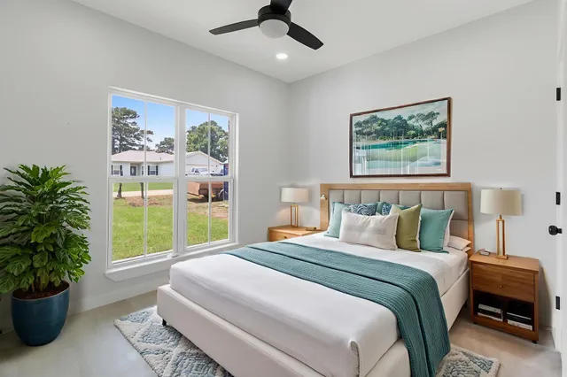a bedroom with a large bed and a window