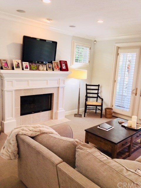 65 Old Course Drive Newport Beach, CA 92660 - Photo 3 of 15 Living room looks out on the front patio and has a wood burning fireplace, plantation shutters and built-in speakers.