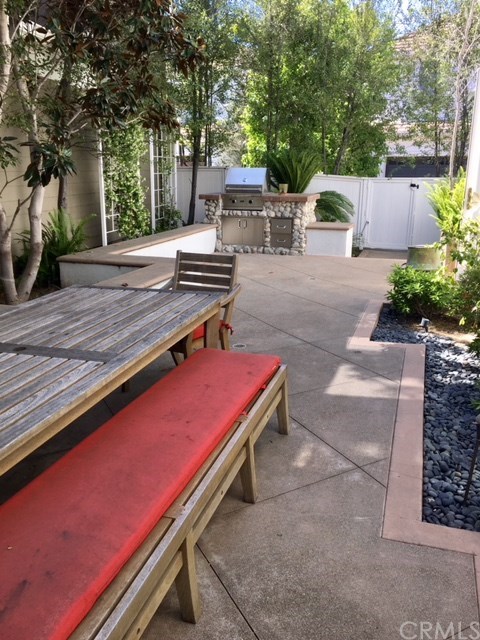 65 Old Course Drive Newport Beach, CA 92660 - Photo 9 of 15 Located on a zero lot line, the side patio features a built-in bbq and gets lots of natural light for dining al fresco!