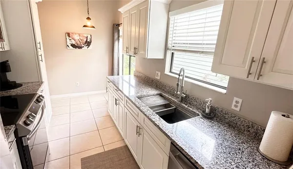 a kitchen with a sink a stove a washer and dryer