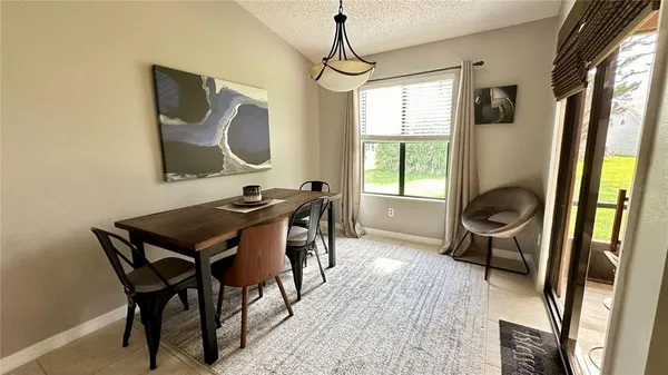 a dining room with furniture and window