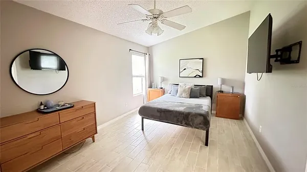 a bedroom with a bed and a flat screen tv
