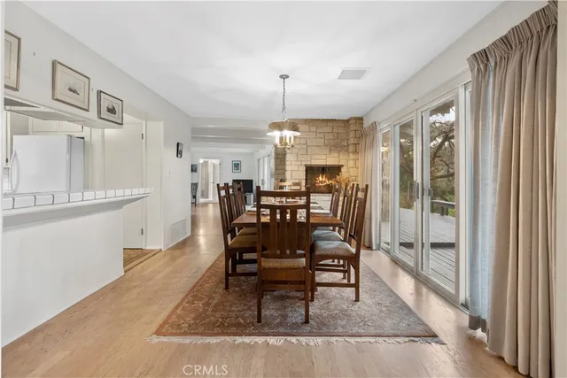 a dining room with furniture a large window and a chandelier