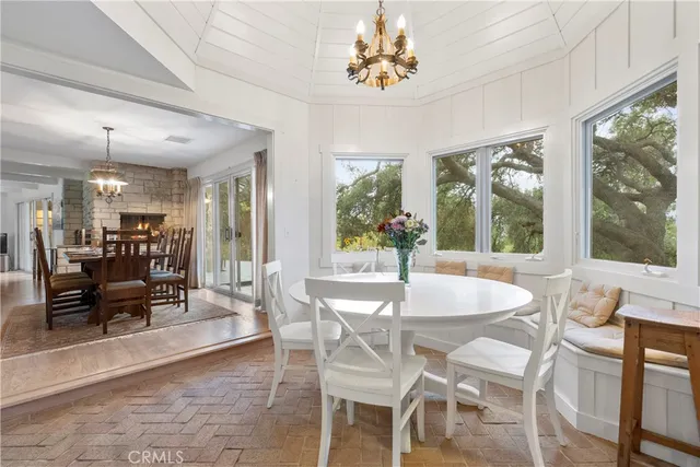 a view of a dining room with furniture wooden floor and chandelier