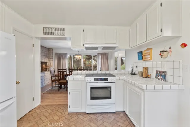 a living room with fireplace furniture and a large window