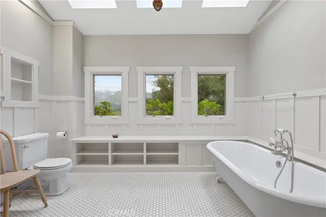 a dining room with furniture a chandelier and wooden floor