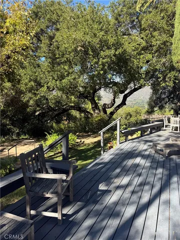 a patio with table and chairs and potted plants