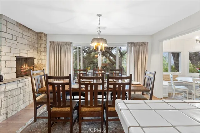 a dining room with furniture a chandelier and wooden floor
