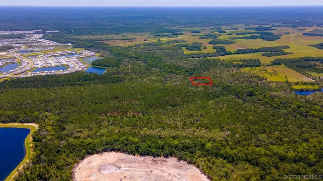 an aerial view of residential houses with outdoor space and river