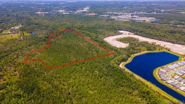 an aerial view of residential houses with outdoor space and city view