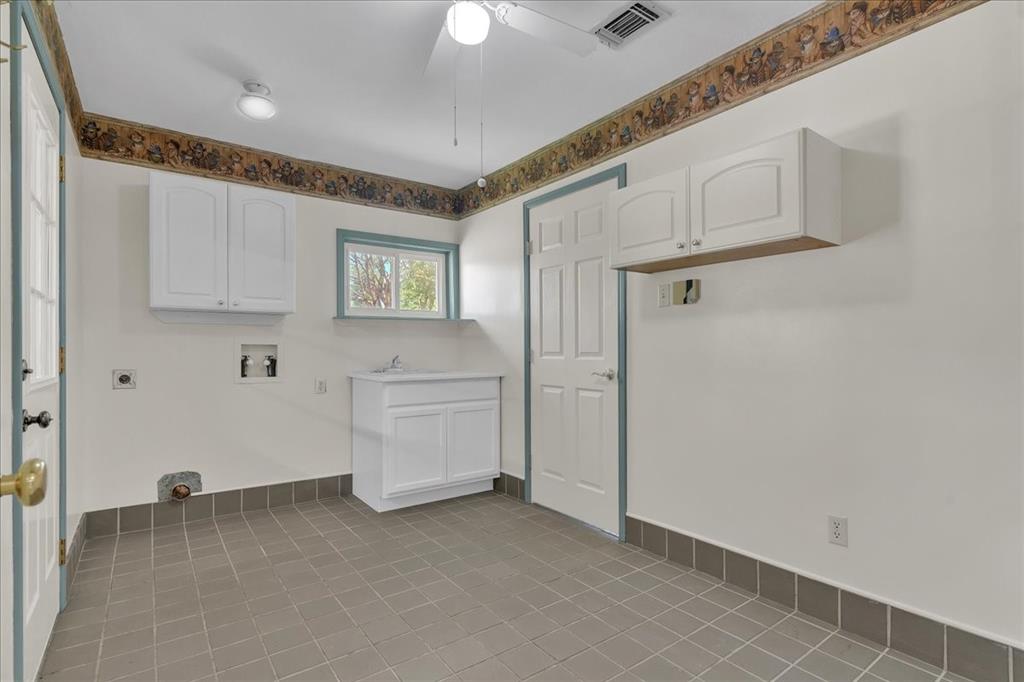 1900 South Duncanville Road Red Oak, TX 75154 - Photo 29 of 39 Laundry room with utility sink and plenty of room for a refrigerator and freezer!