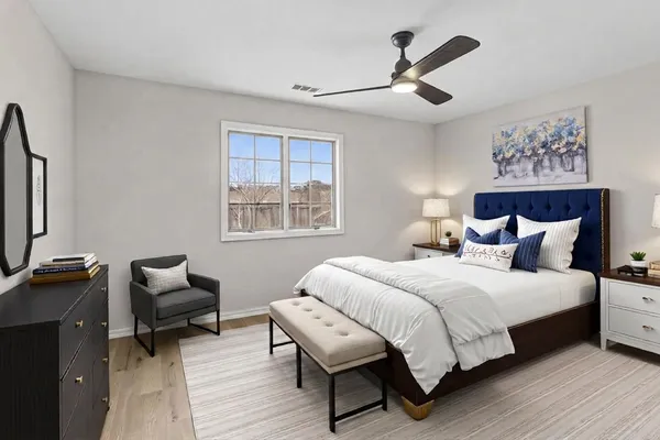 a bedroom with a bed a couch and a window