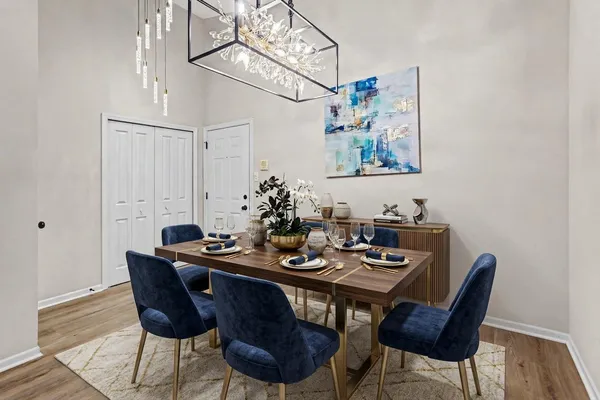 a view of a dining room with furniture wooden floor and a chandelier