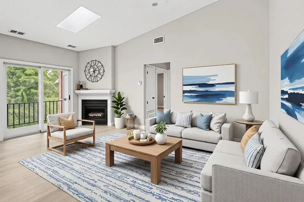 a living room with furniture fireplace and a large window