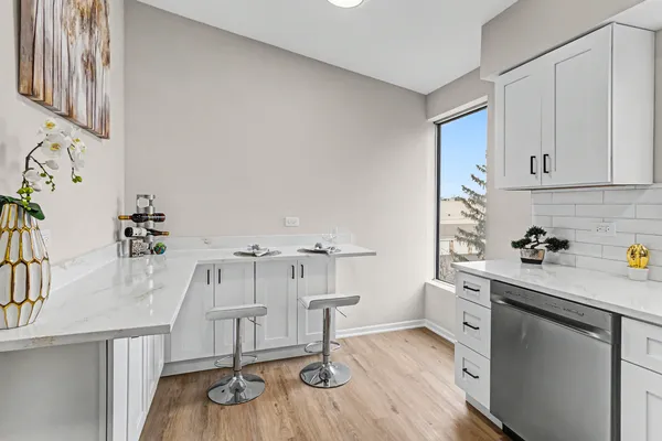a kitchen with stainless steel appliances a stove a sink and cabinets