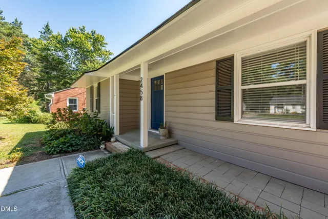 a view of house with backyard and garden