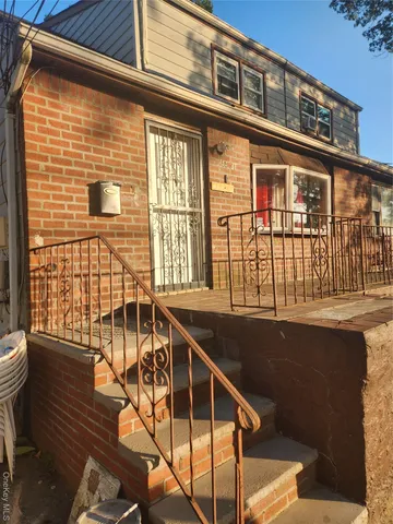 a front view of a house with many windows