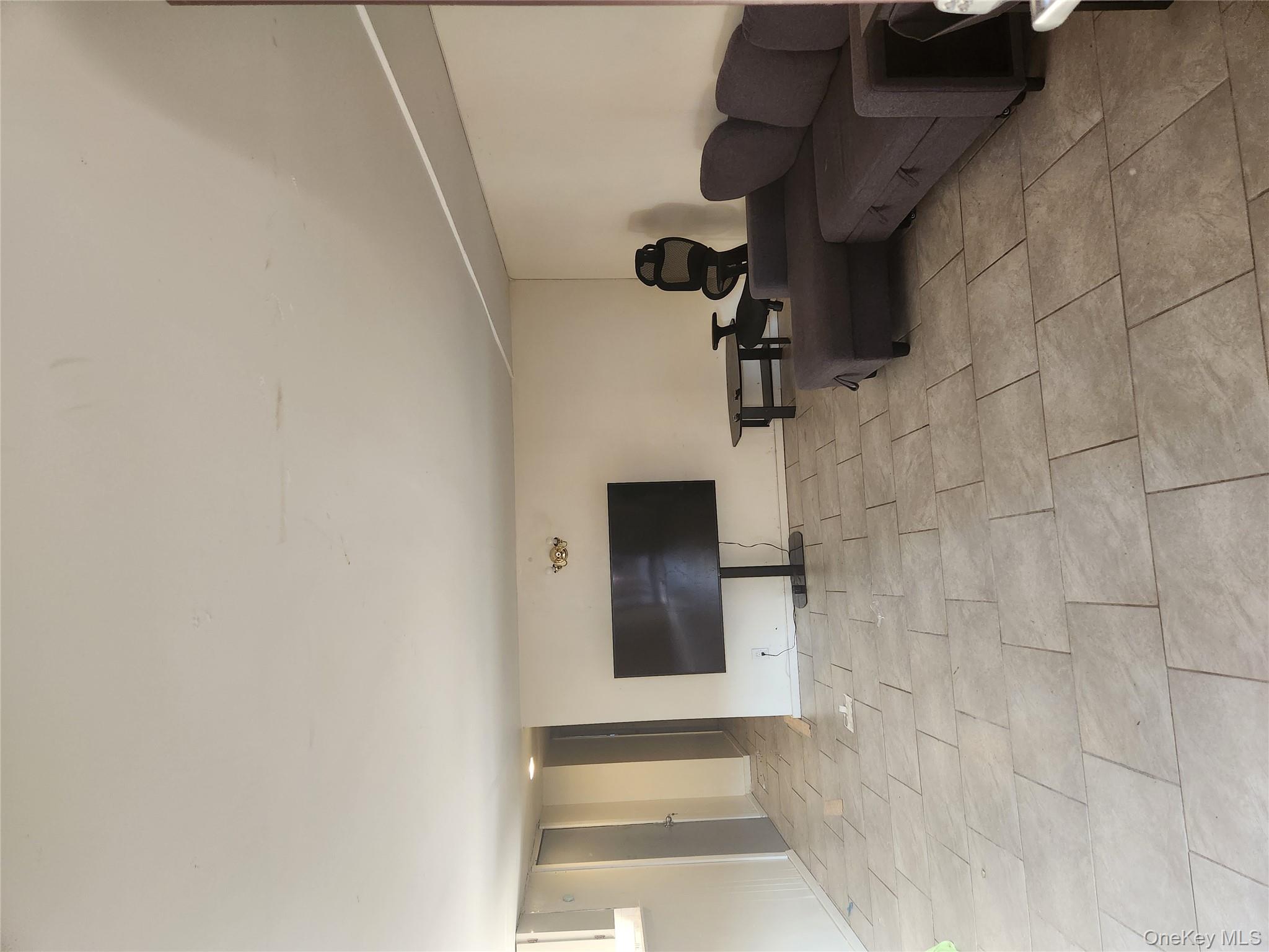 144-37 231st Street Queens, NY 11413 - Photo 3 of 5 a living room with furniture and a couch