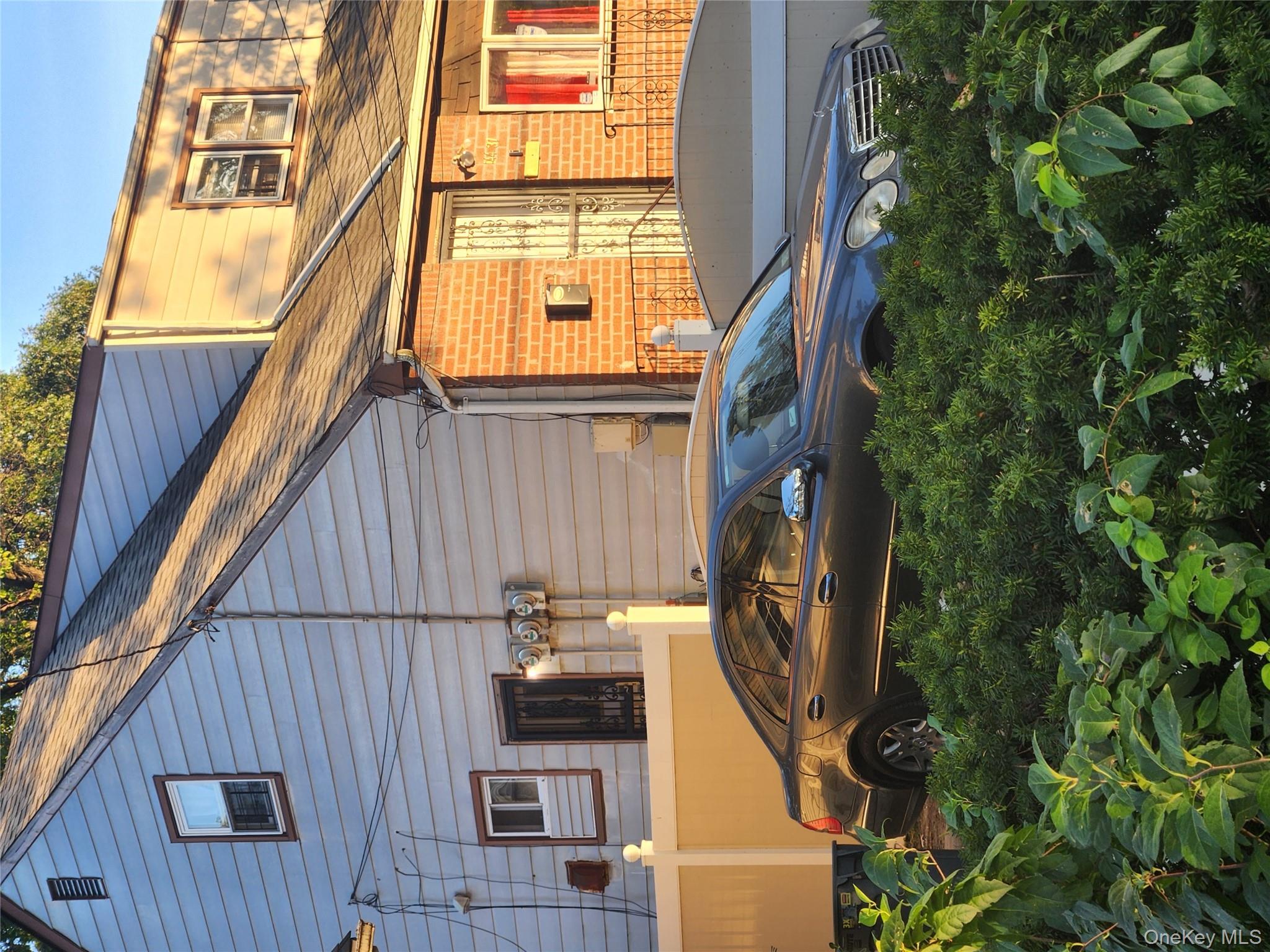 144-37 231st Street Queens, NY 11413 - Photo 4 of 5 a front view of a house with a yard