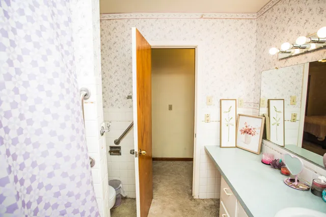 a bathroom with a sink mirror and vanity