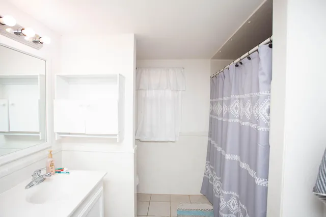 a view of a livingroom with furniture and bedroom