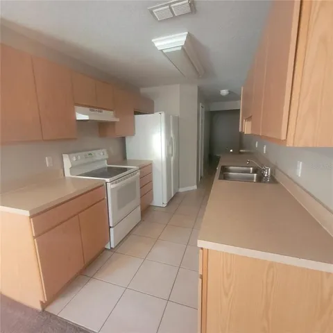 a kitchen with a sink and a stove top oven