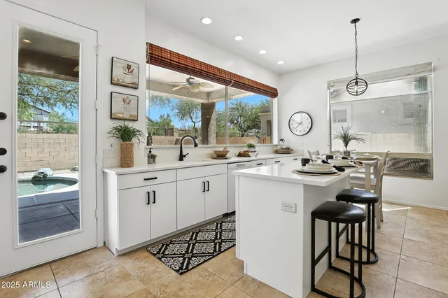 a kitchen with stainless steel appliances kitchen island granite countertop a sink and cabinets