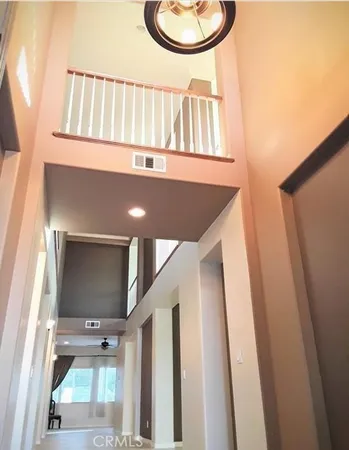 a view of staircase with white walls and a window