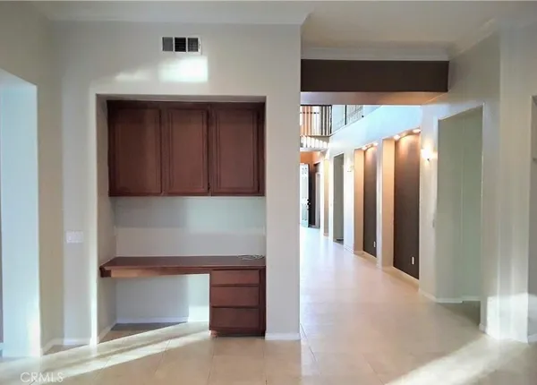 a view of a hallway with entryway and wooden floor