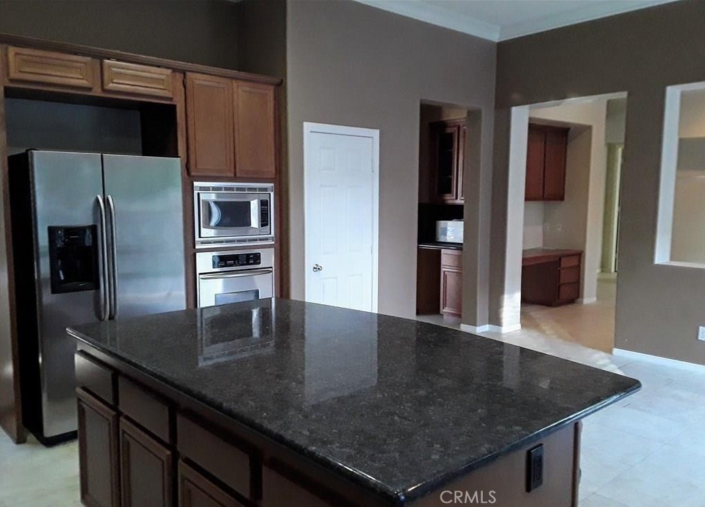 12701 Palm View Way Riverside, CA 92503 - Photo 14 of 26 a kitchen with stainless steel appliances granite countertop a sink a microwave and refrigerator